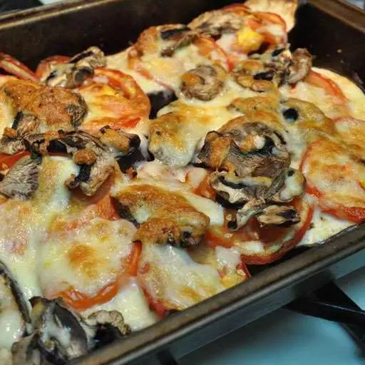 Баклажани в духовці з помідорами, сиром та грибами